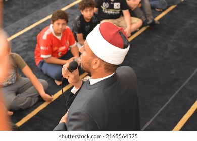 Cairo, Egypt, May 31 2022: A Mosque Preacher Imam Performs A Religious Khutbah (sermon) For Young Muslim Children Inside A Mosque During The Summer Islamic Educational Program For Kids In The Mosque