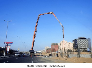 Cairo, Egypt, October 3 2022: A Truck-mounted Concrete Boom Pump At The Side Of The Road Pouring Concrete To A New Building, Selective Focus Of Concrete Truck At The Construction Site Of New Building