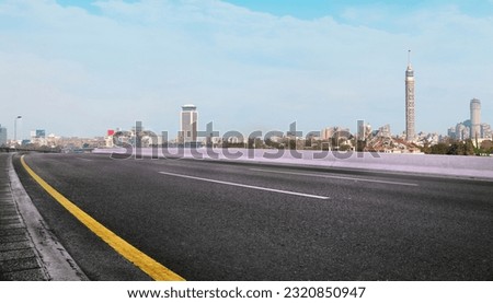 Cairo Street at Morning in Egypt - road in Cairo city with buildings and Cairo tower in Background 	

