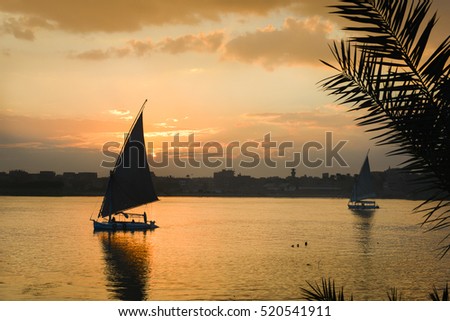 Similar – Silhouette einer ägyptischen Stadt mit Segelboot im Vordergrund und pastellrosa-lila farbenem Himmel, Sonnenuntergangsstimmung