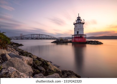 Caisson (sparkplug) Style Lighthouse Under Soft Golden Light With A Bridge In The Background. Tarrytown Light On The Hudson River In New York. 