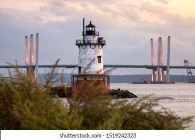 Caisson (sparkplug) Style Lighthouse Under Soft Golden Light With A Bridge In The Background. Tarrytown Light On The Hudson River In New York. 