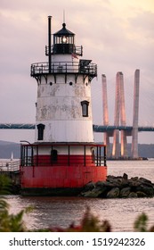 Caisson (sparkplug) Style Lighthouse Under Soft Golden Light With A Bridge In The Background. Tarrytown Light On The Hudson River In New York. 