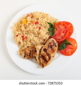 Cajun Rice And Chicken With A Sliced Tomato Seen From Above