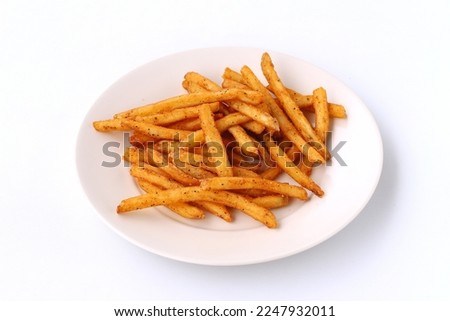Cajun seasoned french fries served on plate isolated on white background