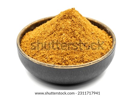 Cajun spice powder isolated on white background. Powdered dried cajun in bowl. Close up
