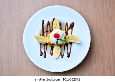 Cake With Banana Split And Cherry  In Plate