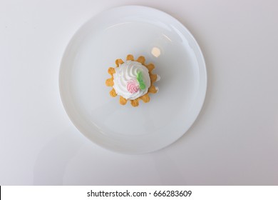 Cake Basket With Cream On A Plate Isolated On White Table. Top View.