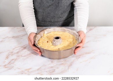Cake batter in a bundt cake pan to bake apple bundt cake with caramel glaze. - Shutterstock ID 2228532927