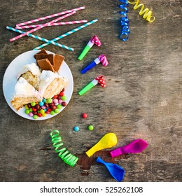 Cake, Candy, Chocolate, Whistles, Streamers, Balloons On Holiday Table. Concept Of Children's Birthday Party. View Top.