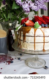 A Cake With Caramel Drizzle And Red Roses 