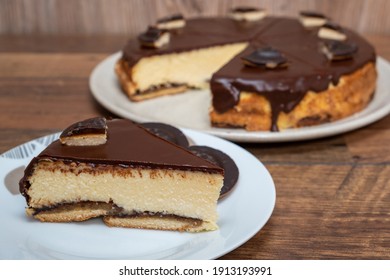 Cake with Chocolate Glaze and orange biscuit on wooden background