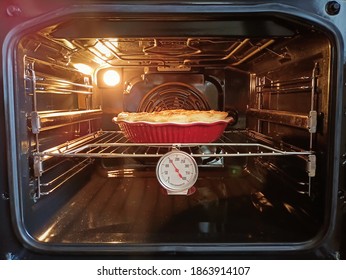 The cake is cooked in the oven, the thermometer shows the temperature - Powered by Shutterstock