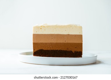 cake cut with sponge biscuit and three chocolate mousse layers. Chocolate mousse cake on the white background - Powered by Shutterstock