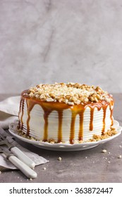 Cake Decorated With Salted Caramel Sauce And Nuts,  Selective Focus