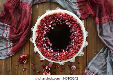 Cake With Jelly, Cranberry And Pomegranate On A Brown Wooden Table. Gala Dinner View From The Top