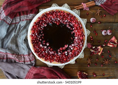 Cake With Jelly, Cranberry And Pomegranate On A Brown Wooden Table. Gala Dinner View From The Top