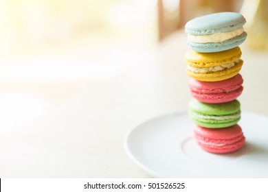 Cake macaron or macaroon isolated on white background, sweet and colorful dessert,Cake macaron or macaroon on white dish background from above, almond cookies, pastel colors, vintage card