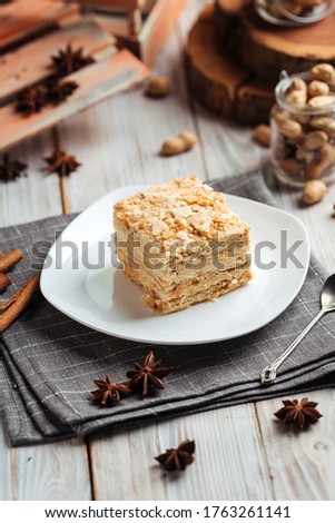 Cake made of thin crispy layers and cream napoleon, vertical