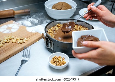 Cake Making. Cooking Concept. Professional Confectioner Decorating Tasty Cake With Chocolate Frosting