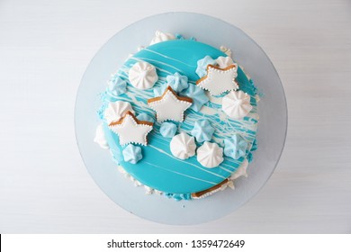 Cake Of The Marine, Sea Theme, Decorated With Blue Mirror Glaze, Stars, Meringues On A White Background. Children's, Teen's, Novelty Birthday And Party Celebrations. Top View.