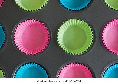 Cake Or Muffin Tin With Colourful Paper Cases Useful For Baking Concepts