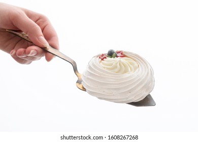 Cake On A Pastry Shovel In A Hand Isolated On A White Background