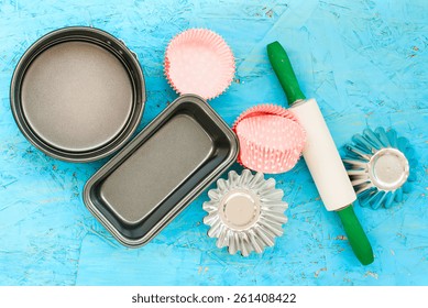 Cake Pans And Round Metal Bakeware, Wooden Rolling Pin On A Wooden Background