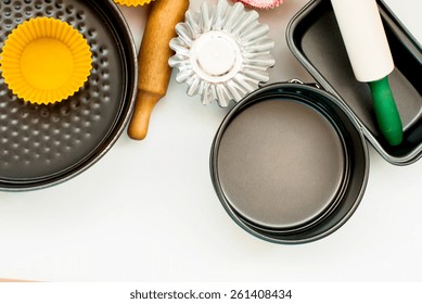 Cake Pans And Round Metal Bakeware, Wooden Rolling Pin On A Wooden Background