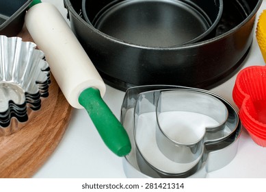 Cake Pans And Round Metal Bakeware, Wooden Rolling Pin On A Wooden Background