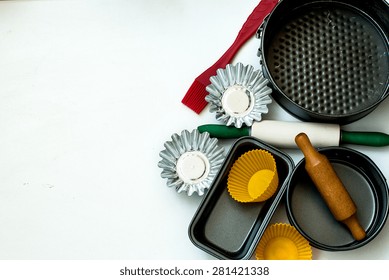 Cake Pans And Round Metal Bakeware, Wooden Rolling Pin On A Wooden Background