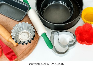 Cake Pans And Round Metal Bakeware, Wooden Rolling Pin On A Wooden Background