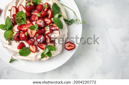 Cake Pavlova with whipped cream, fresh strawberrie and mint, banner, menu, recipe place for text, top view.