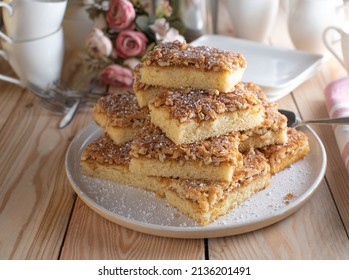 Cake Platter With Fresh Baked Caramelized Almond Sheet Cake. Served Stacked On Wooden Table.