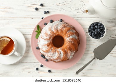 Cake With Powder Sugar And Blueberry On Wooden Background, Top View