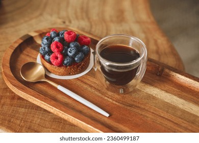Cake with raspberry and cup of coffee.