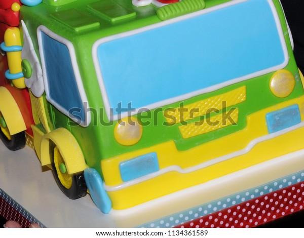 Cake in\
the shape of a car. Colorful cake.\
Clouse-up