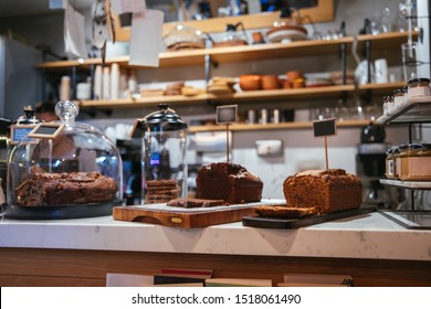 Cake Shop, Cafe Or Coffee Shop With Christmas Chocolate Or Fruit Cakes On The Table. Winter Cakes In Cafe Or Coffeeshop.