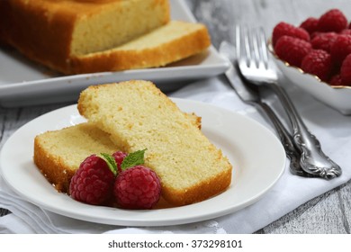 Cake Slices Served On Dessert Plate With Fresh Berries And Pound Cake On Side, Selective Focus