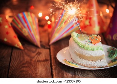Cake With Sparkler On Table On Wooden Background