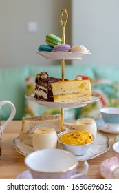 Cake Stand For Afternoon English Tea With Cakes, Macaroon, Sandwich And More Food.