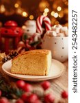 Cake surrounded by festive decorations, creating a cozy holiday vibe. Perfect for Christmas, holiday season, or festive celebrations. Keywords: Christmas cake, holiday food.