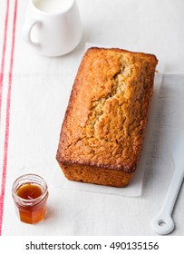 Cake, Tea Loaf With Jam And Cream On A Textile White Background. Rustic Style.