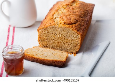 Cake, Tea Loaf With Jam And Cream On A Textile White Background. Rustic Style.