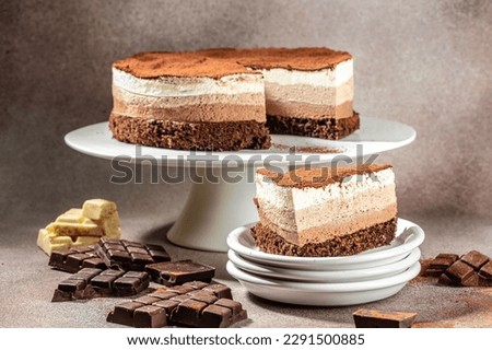 cake Three chocolates on a light background. Birthday, holidays, sweets, catering banner, menu recipe,