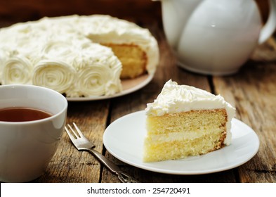 cake with vanilla cream in the form of roses on a dark wood background. tinting. selective focus
