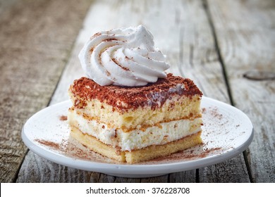 Cake With Whipped Cream On Wooden Table