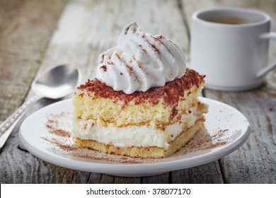 Cake With Whipped Cream On Wooden Table