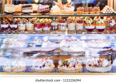 Cakes In The Bakery Window. Rich Variety Of Chocolates And Candies In Display Window Of Pastry Shop. Cookies Showcase.