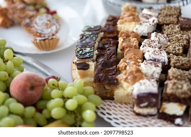 Cakes And Fruit On The Table. Party Food. The Table Is Prepared For A Holiday Party For Guests.